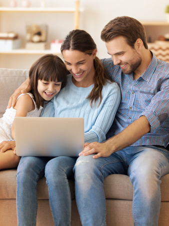 A family of three sitting on a couch and looking at the Express Scripts Canada cost containment section of the website