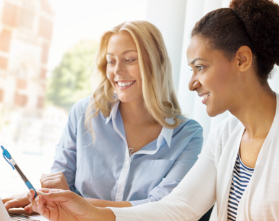 Two young happy healthcare workers smiling as they look at the Express Scripts Canada website